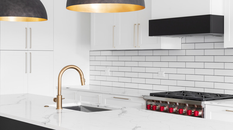 white subway tile backsplash with gray grout in a kitchen