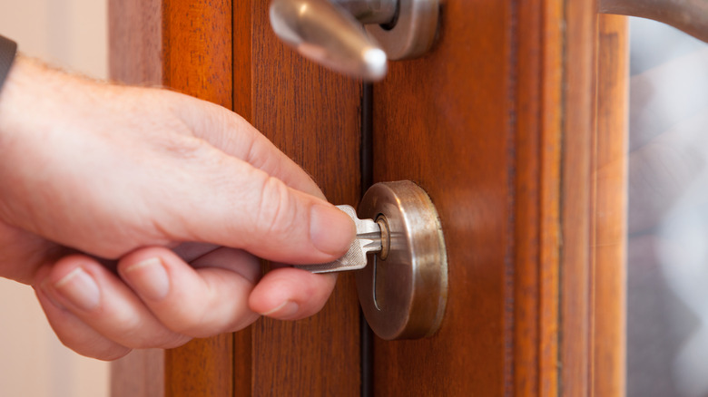 Person unlocking lock with key