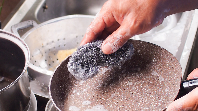 steel wool scrubber in hand