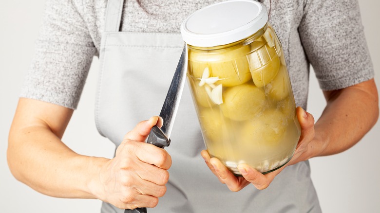 Woman tries to open jar