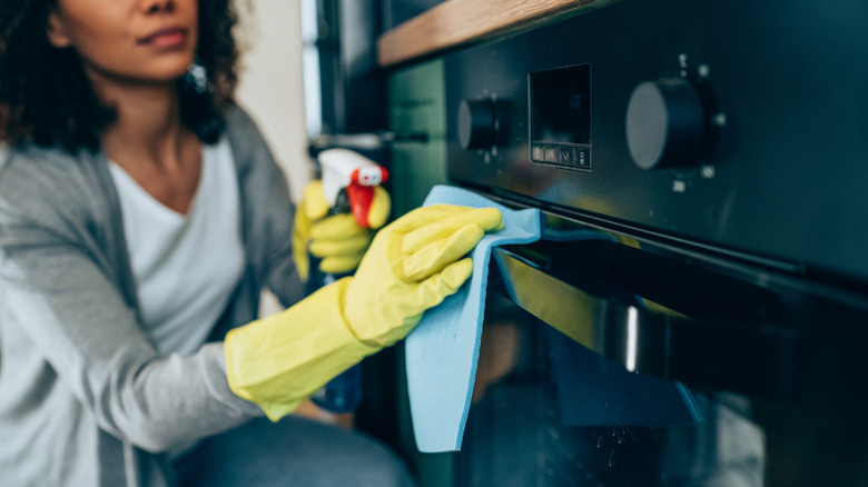 Woman cleaning her oven
