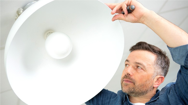 Person installing pendant light