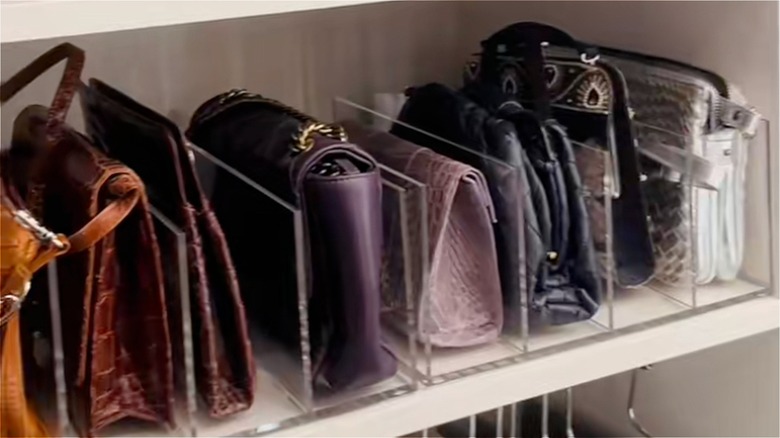 clear dividers used to sort handbags in a closet