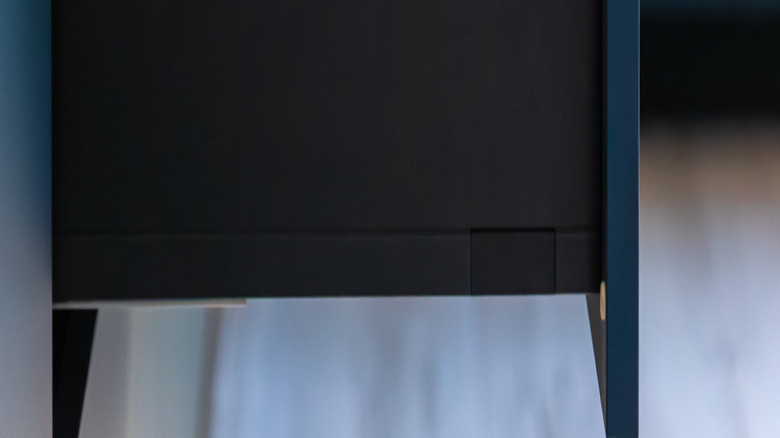 A deep blue kitchen drawer that is pulled out