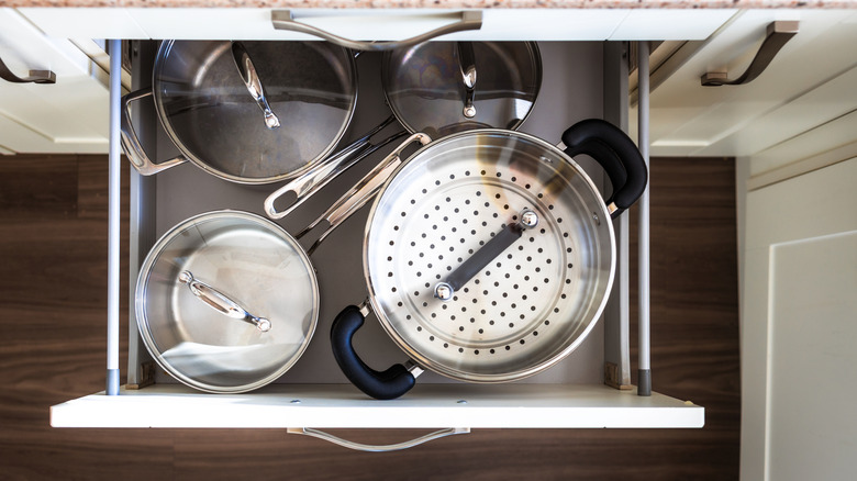Top view of cookware neatly arranged inside a kitchen drawer