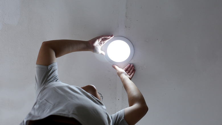 person fixing garage light