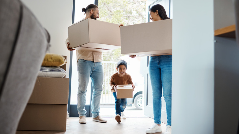 new homeowner family carrying boxes