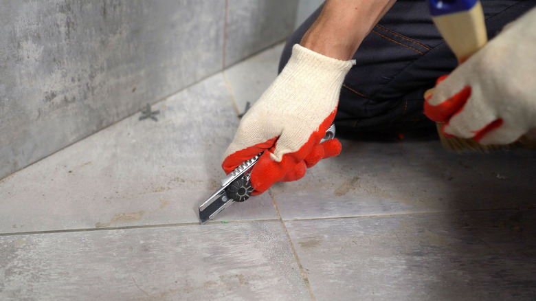 person using utility knife