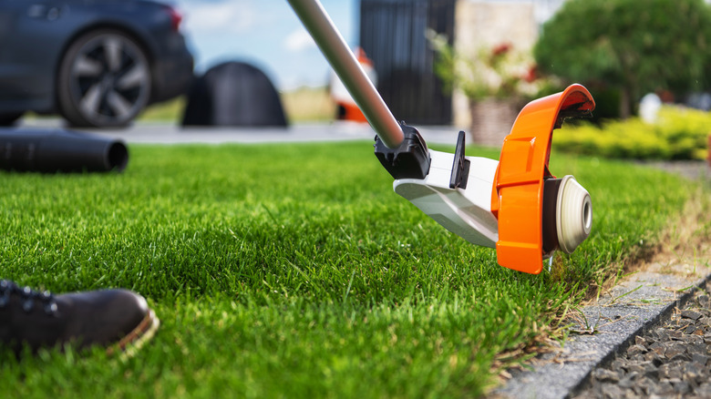 person using weed eater
