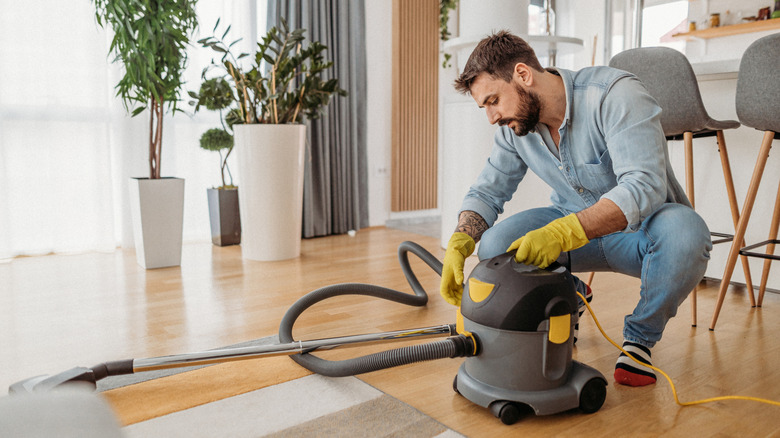man using wet dry vacuum