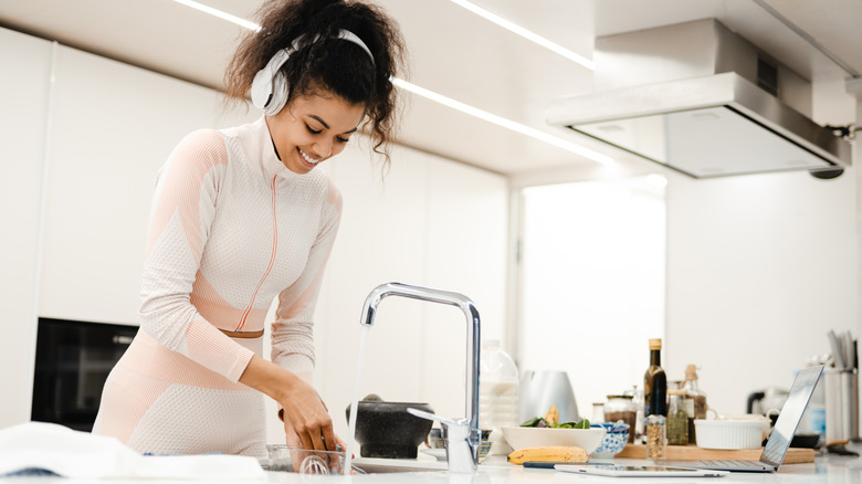 Woman washing blender