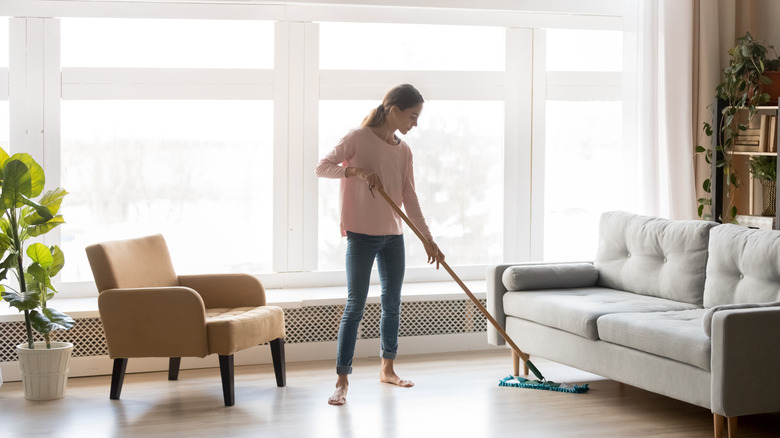 Woman dusting light oak floors