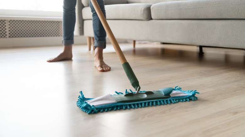 Person mopping laminate floor