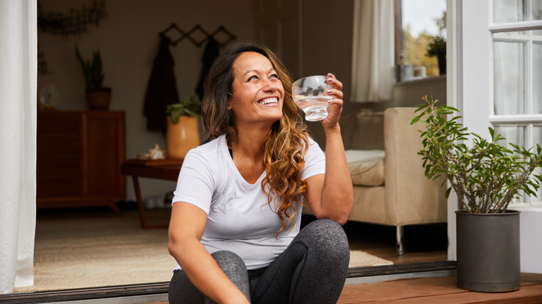 woman sitting at the threshold of her home