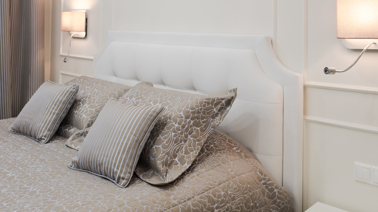 Bed with white tufted upholstered headboard