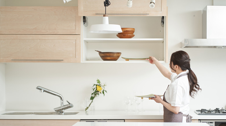A woman organizes her kitchen