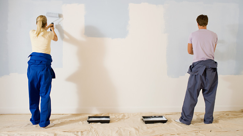people painting a wall