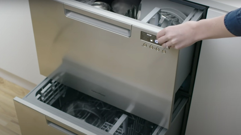 woman opening a dishwasher drawer