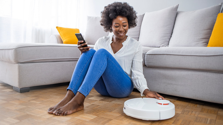 woman and robot vacuum