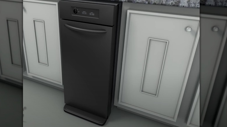 gray trash compactor in cabinet