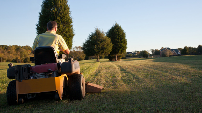 A person mowing on the perfect flat terrain for a zero-turn mower