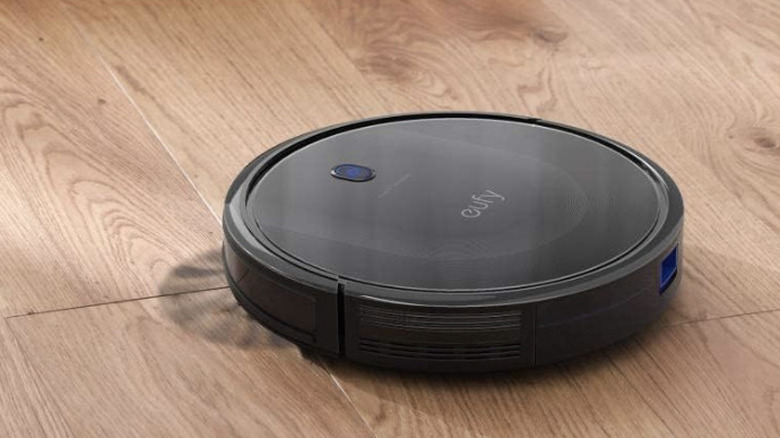 black eufy robovac on hard wood flooring