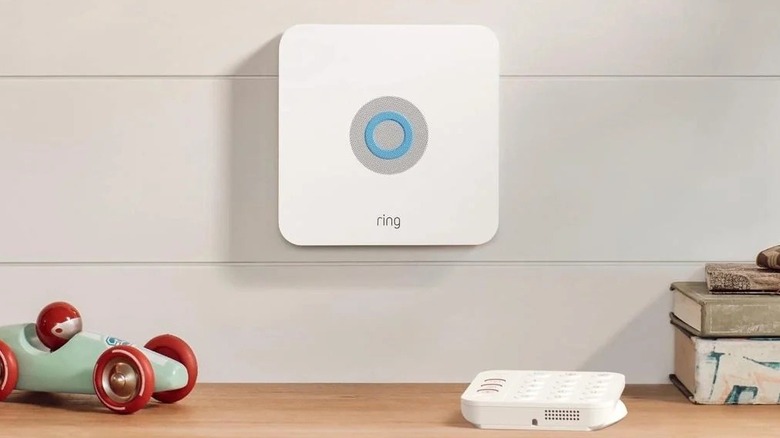 Ring security system base unit attached to wall by a desk