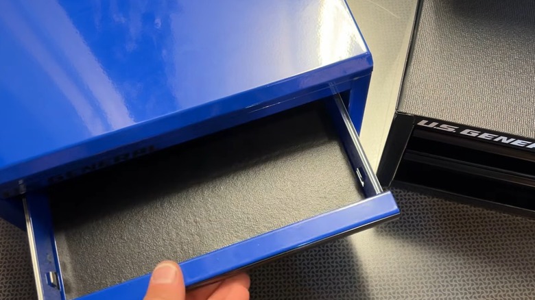 Person opening drawer on blue U.S. General toolbox