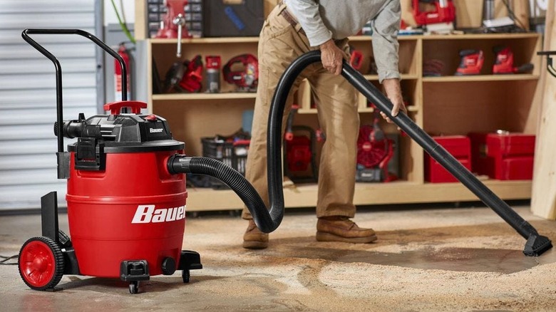 Person using the 16-gallon Bauer wet/dry vacuum﻿