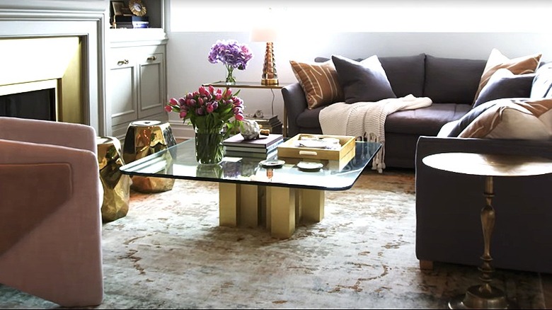 A modern living room with glamorous gold and brass decor.