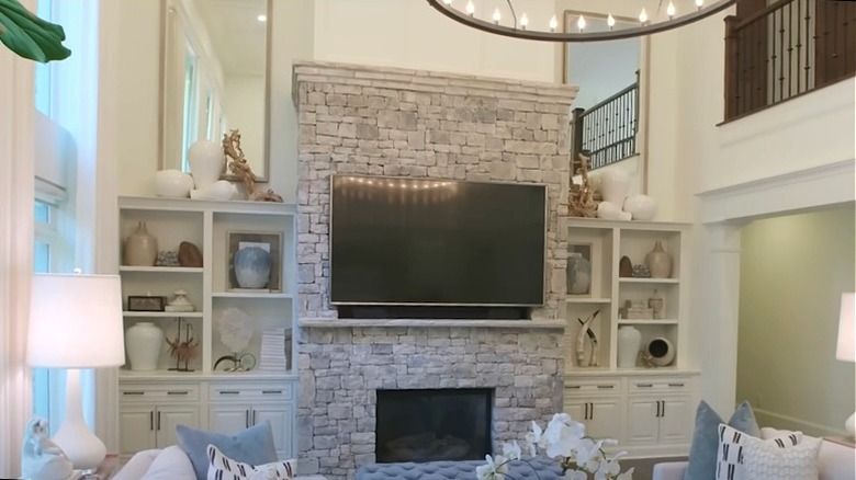 A bright and modern living room with a large stone fireplace