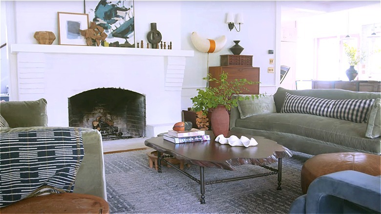 A living room with green sofas and a wood coffee table.