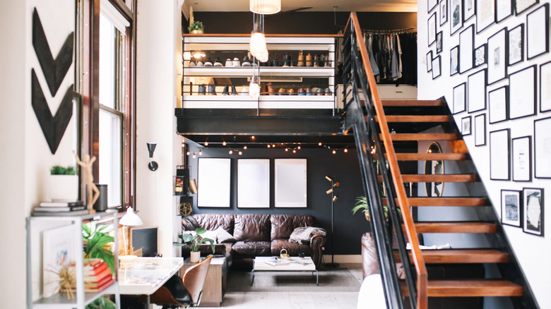 A loft apartment with a view of the living space downstairs and closet upstairs