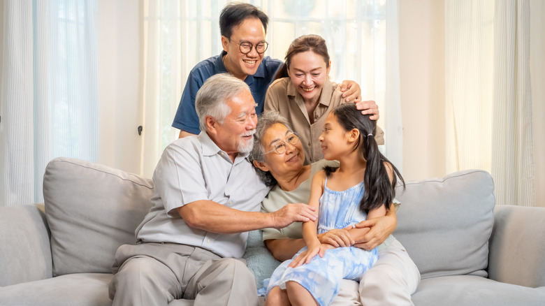 A multigenerational family sitting on a couch