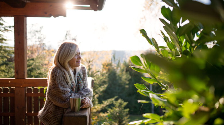 A person smiling while looking at the garden