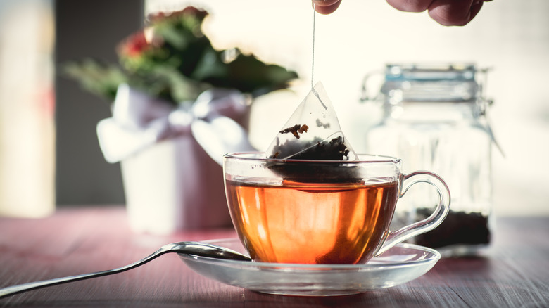 Black tea bag in mug