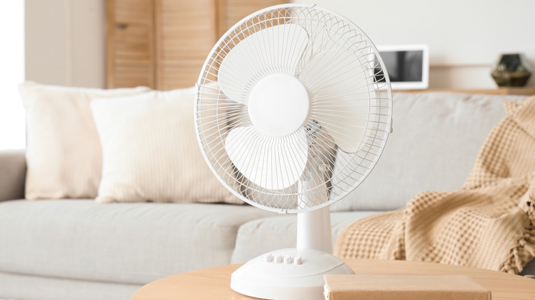 Living room with a fan on a wood table