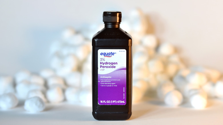 Bottle of hydrogen peroxide with cotton balls