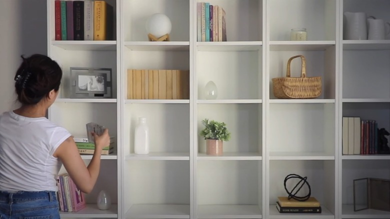 Woman decorating a BILLY bookcase