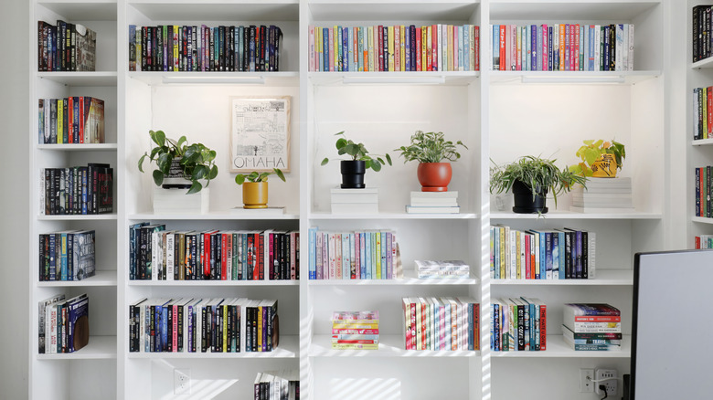 white floor-to-ceiling bookshelves in a home office