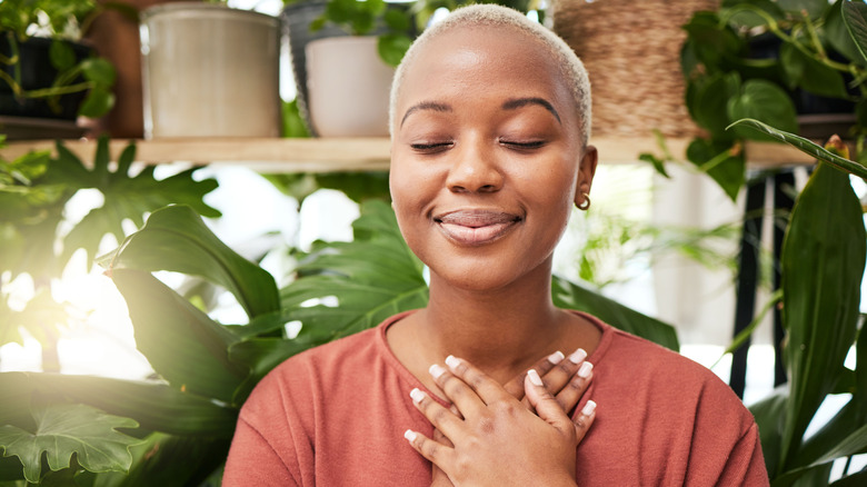 Woman happy and Zen like in greenhouse