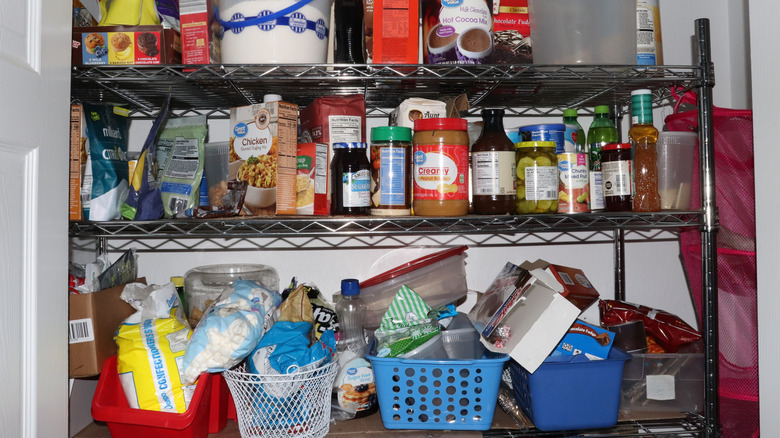 An interior view of a messy and cluttered pantry