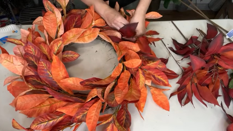 A fall wreath made of plastic leaves