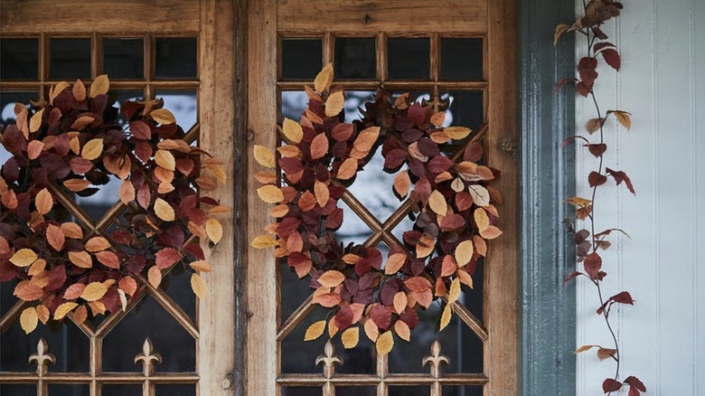 Two fall wreaths from IKEA hung on exterior double doors