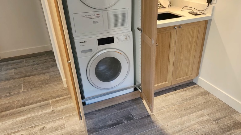 IKEA cabinet is turned into washer storage unit.