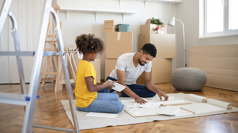Dad and daughter building furniture