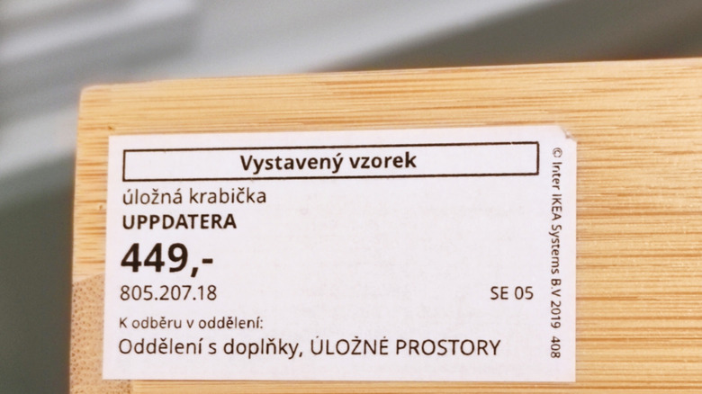 An IKEA date tag underneath a wooden table.