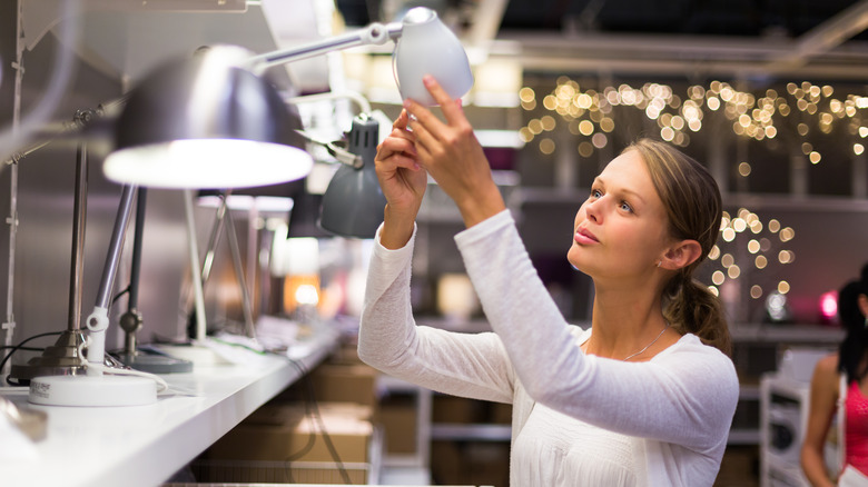 Woman looking at lamp