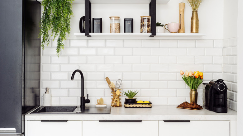A neat and organized kitchen sink area.
