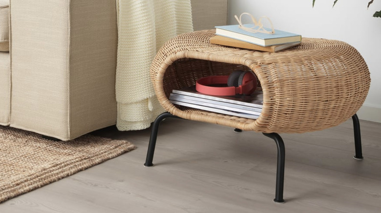GAMLEHULT ottoman with storage next to a sofa, filled with items